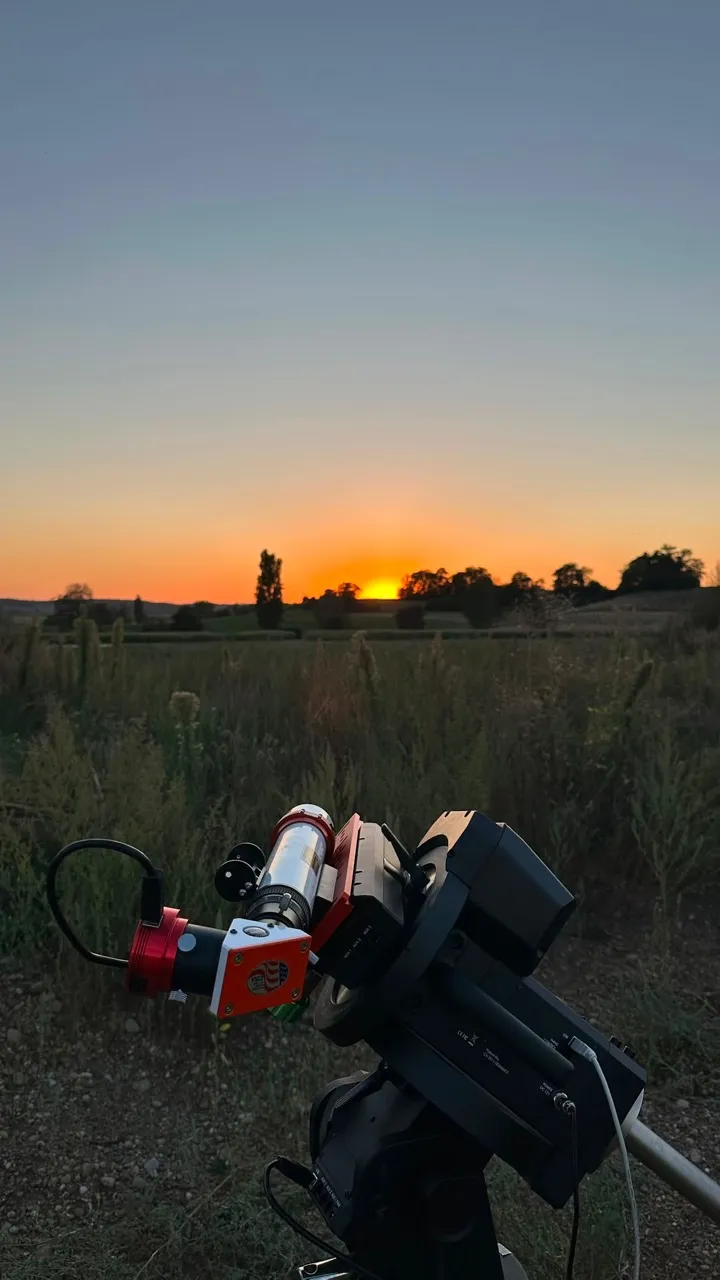 H-alpha solar telescope and camera on a tracking mount at sunset